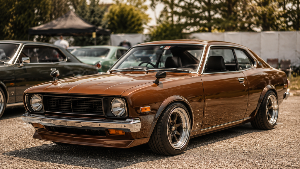 Classic brown enthusiast car parked at an informal car meet