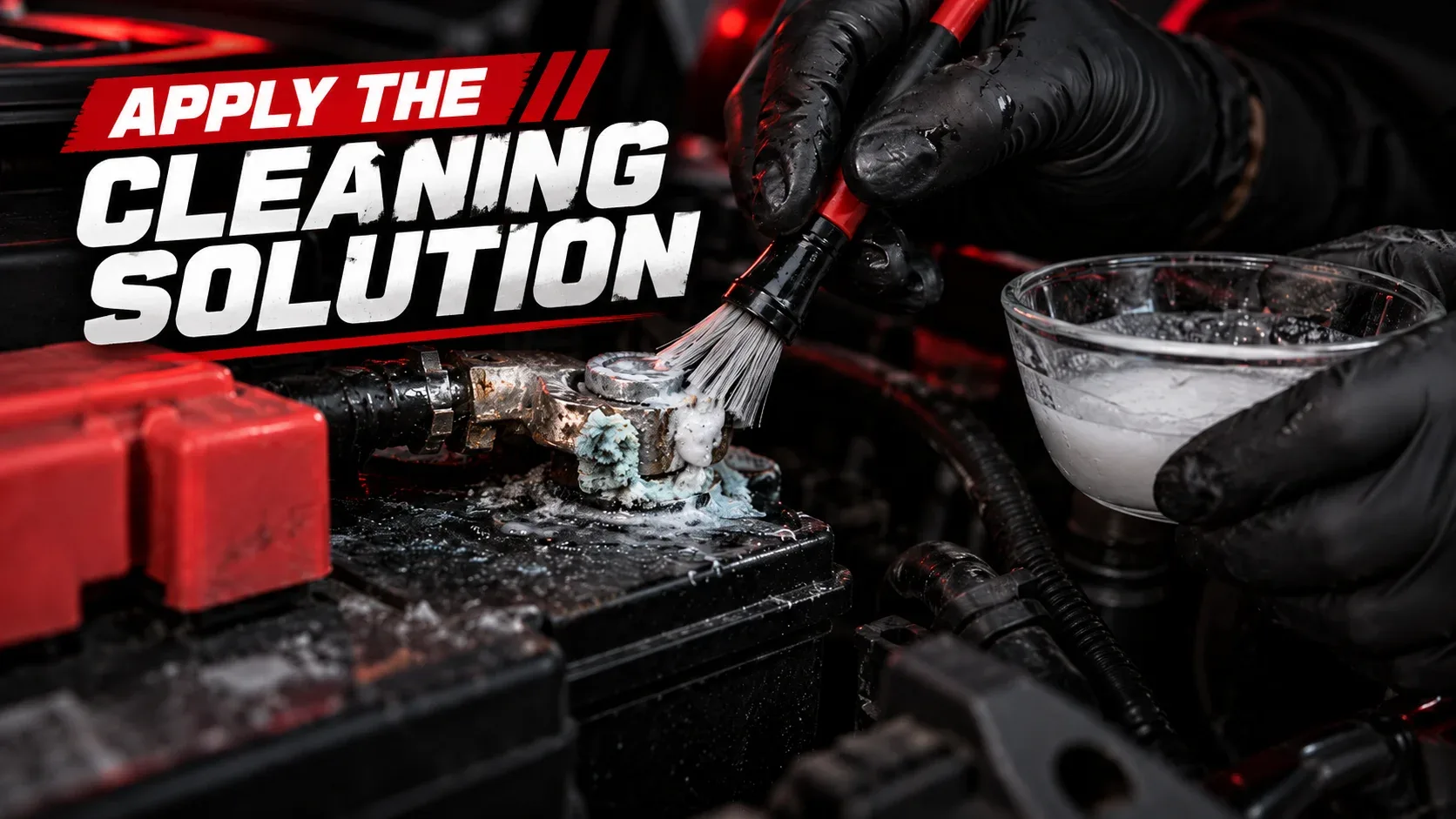 Gloved hands applying cleaning mixture to corrosion on a battery terminal